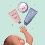 a baby with a hand raised above a lotion